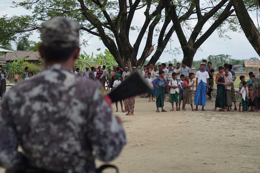 Soldiers oversee a crowd in Myanmar