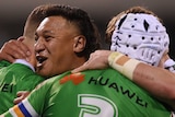 Four Canberra Raiders players embrace as they celebrate a try against the Bulldogs.