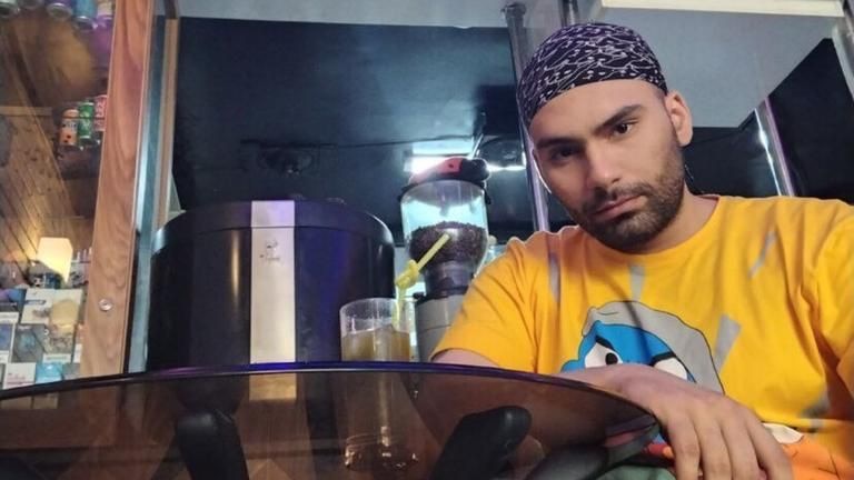Mohsen sitting in a cafe in Tehran