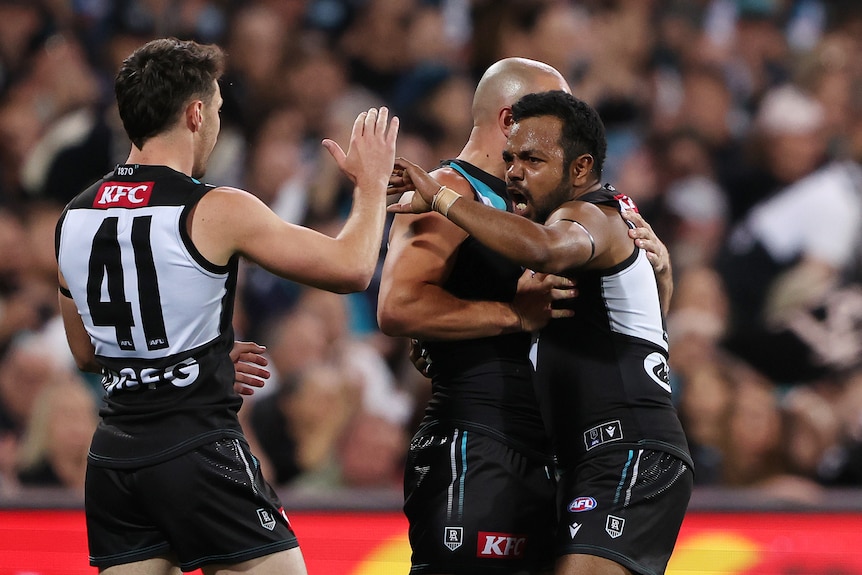 Willie Rioli high fives Port Adelaide after a goal in an AFL semifinal against GWS Giants.