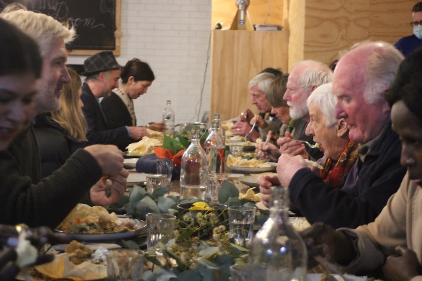 people sitting around a feats of food