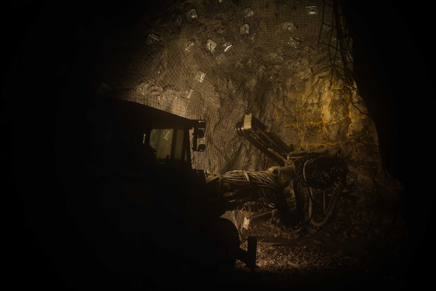 A piece of heavy mining equipment in a mine shaft.