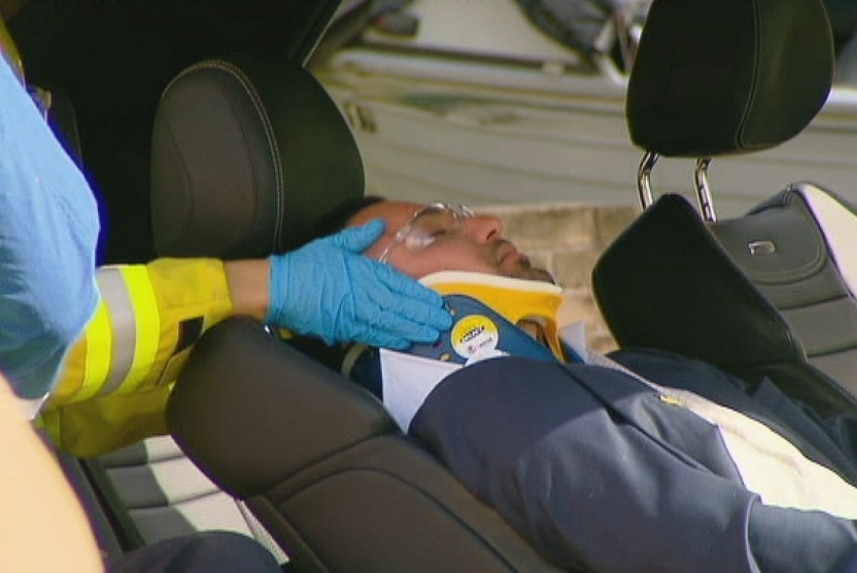 Salim Mehajer lying in his car with a neck brace on being attended by paramedics after a car accident in Lidcombe.