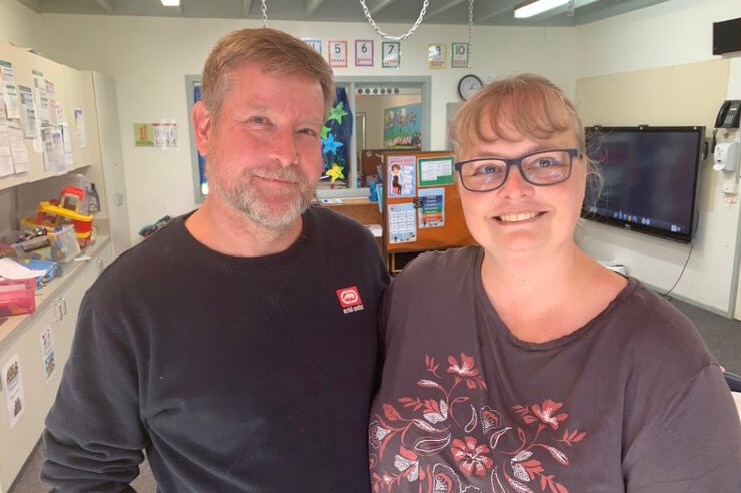 Rod and Martina McNeill stand in an office.