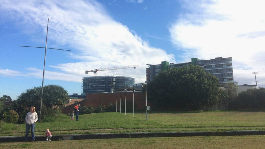 Families in the foreground and building in the background.