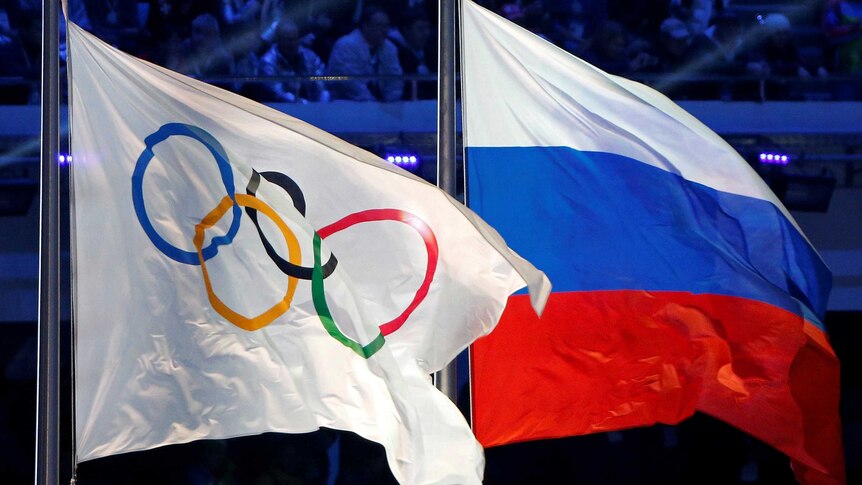 The Olympic and Russian flags fly together.