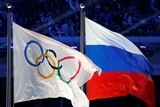 The Olympic and Russian flags fly together.
