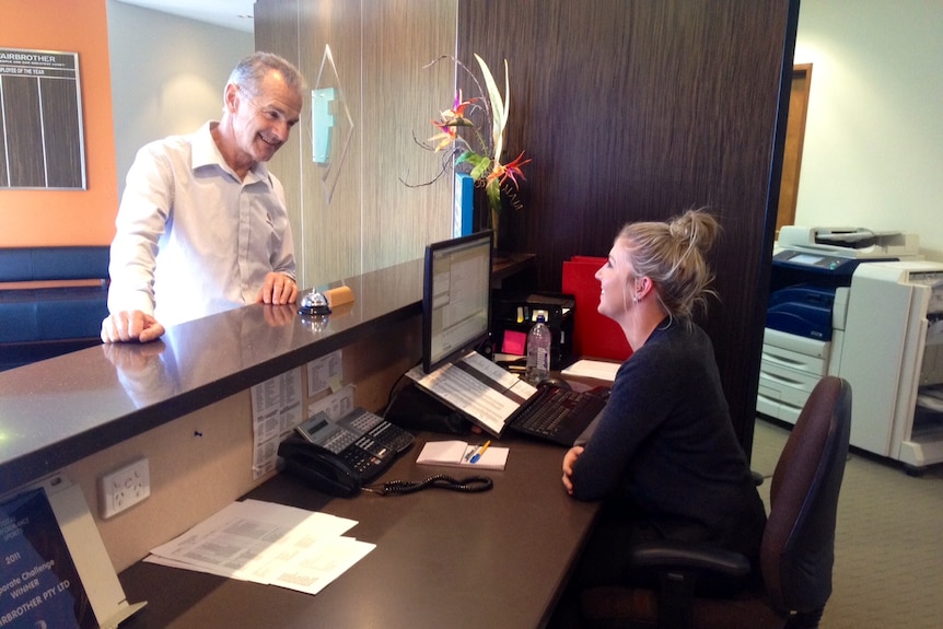 Tasmanian businessman Royce Fairbrother at the reception desk of his business.