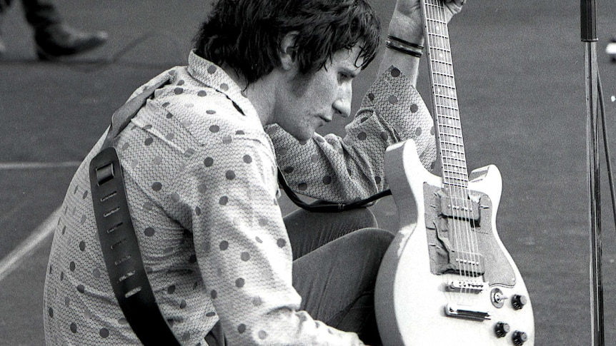 You Am I frontman Tim Rogers checks a guitar during the 1992 Big Day Out in Sydney.