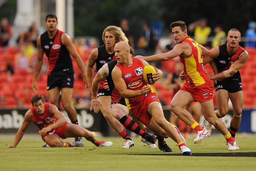 Gold Coast's Gary Ablett looks to kick against Essendon at Carrara in February 2014.