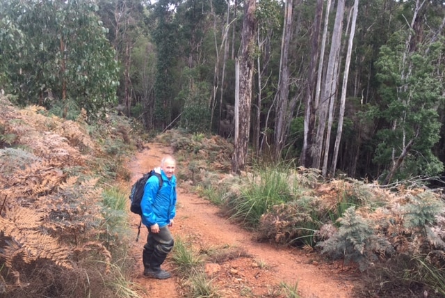Todd Walsh on a track in the Tasmanian bushland.