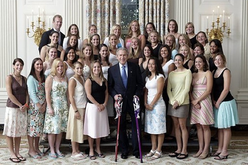 A crowd of women in thongs with President George W Bush