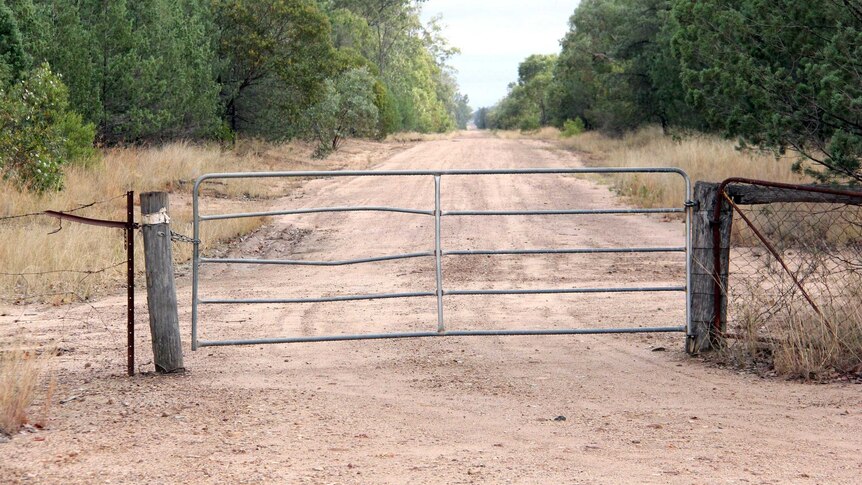 A gate at the entrance to a rural property.