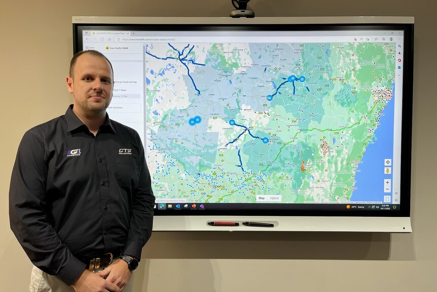 Ben Fenna standing in front of road network map