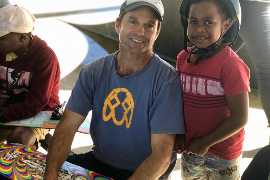 Andrew Moore building a skateboard with a child in Murgon.