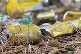 Close up of alcohol cans litter the ground in Doomadgee, June 2018