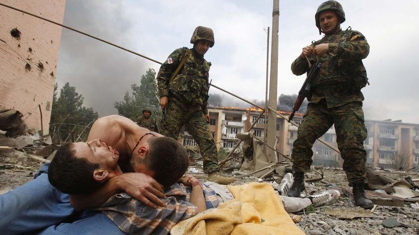 A Georgian man cries over the body of his relative after a bombardment in Gori