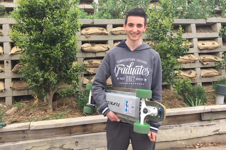 Templestowe College student Liam Evangelista poses with his motorised skateboard