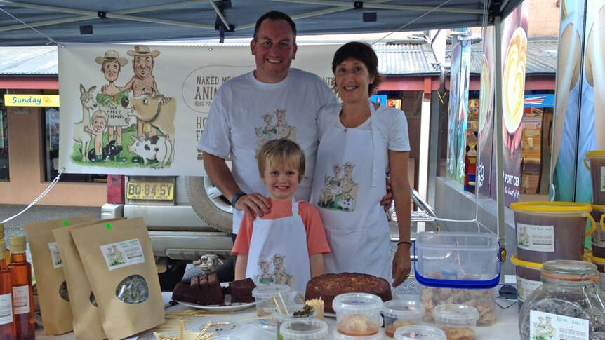 The Love family pose behind their stall at the farmers markets in Port Macquarie.