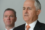 A close-up of Malcolm Turnbull, with Christopher Pyne standing behind him to the left.