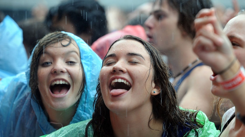 Singing in the rain... Tens of thousands of people braved the rain in Melbourne.