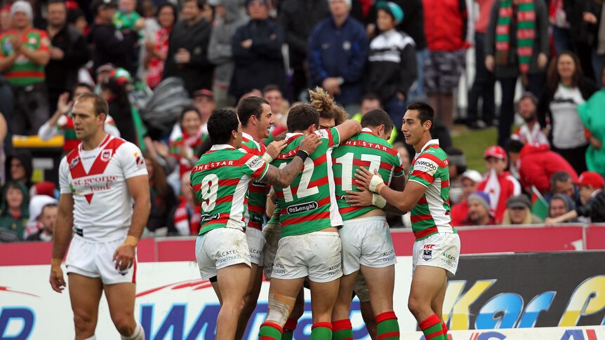 Dragons got done ... Adam Reynolds (obscured) scored a try, converted three and kicked the winning field goal for Souths.