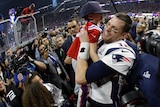 New England Patriots' Tom Brady lifts his son, Ben, after winning NFL Super Bowl LIII in Atlanta.