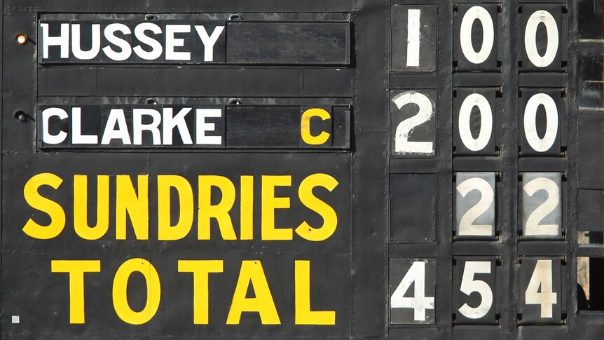 The Adelaide Oval scoreboard shows a Mike Hussey century (top) and a Michael Clarke double-century (below)