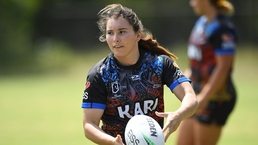 Indigenous All Stars player Sarah Field running with the ball in hand at training