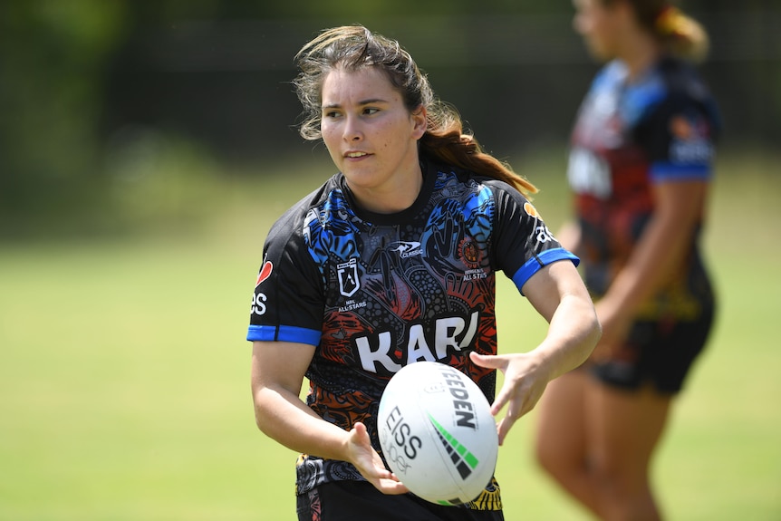 Indigenous All Stars player Sarah Field running with the ball in hand at training