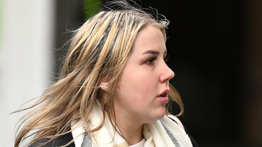 Alisha Fagan appears serious as she stands outside a court building in Melbourne.