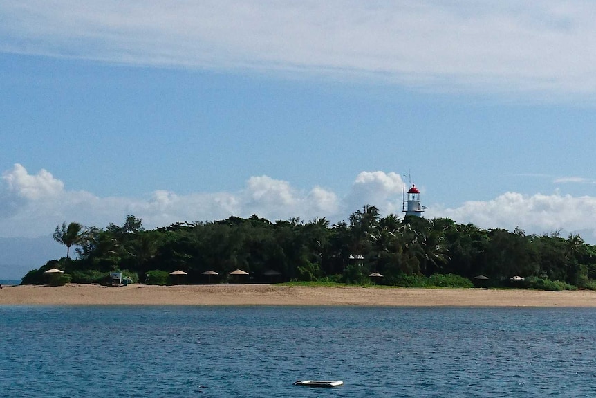 island with lighthouse in the middle