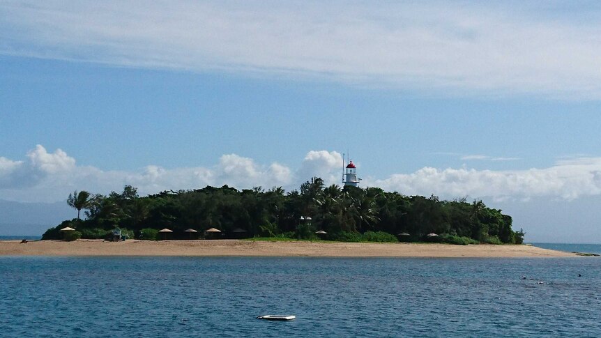 island with lighthouse in the middle