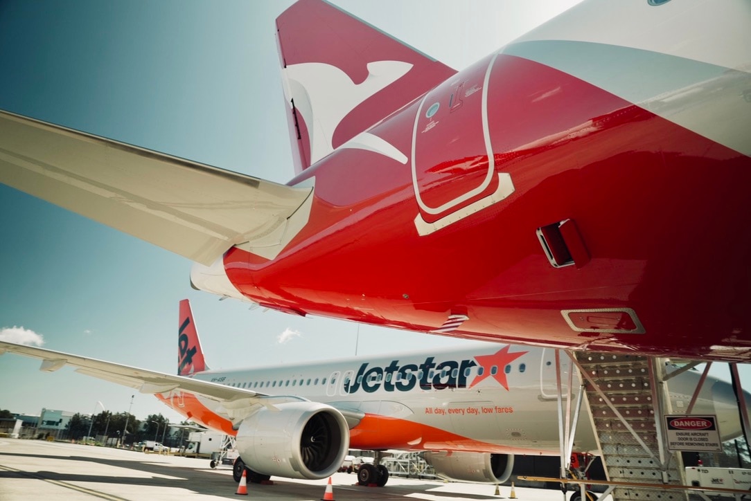 Qantas and Jetstar aircraft at a terminal.