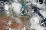A satellite view of two swirling cyclones off the Australian coastline.