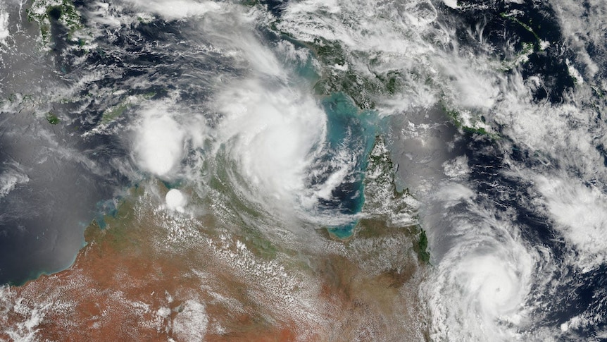 A satellite view of two swirling cyclones off the Australian coastline.