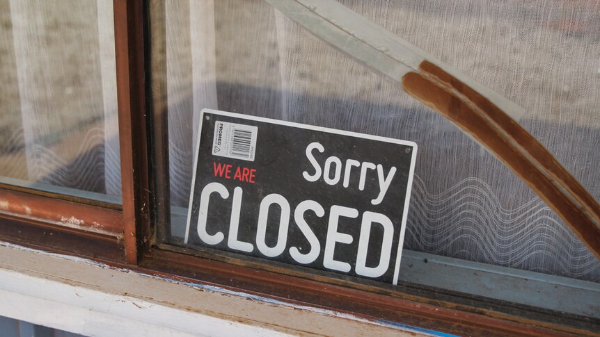 A closed sign sits in a dusty shop front in Ivanhoe.