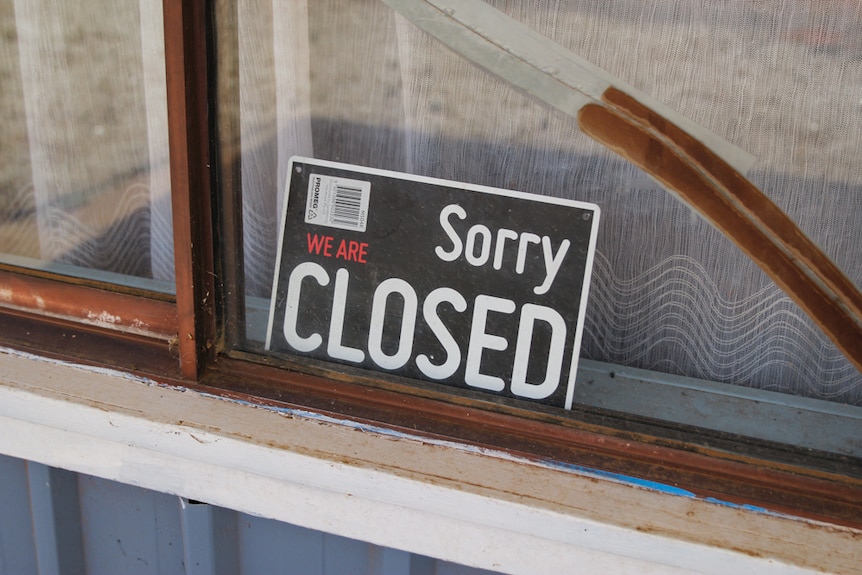 A closed sign sits in a dusty shop front in Ivanhoe.