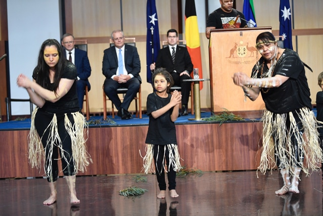 Two Aboriginal women and an Aboriginal girl perform a Welcome to Country to the Prime Minister inside Parliament House