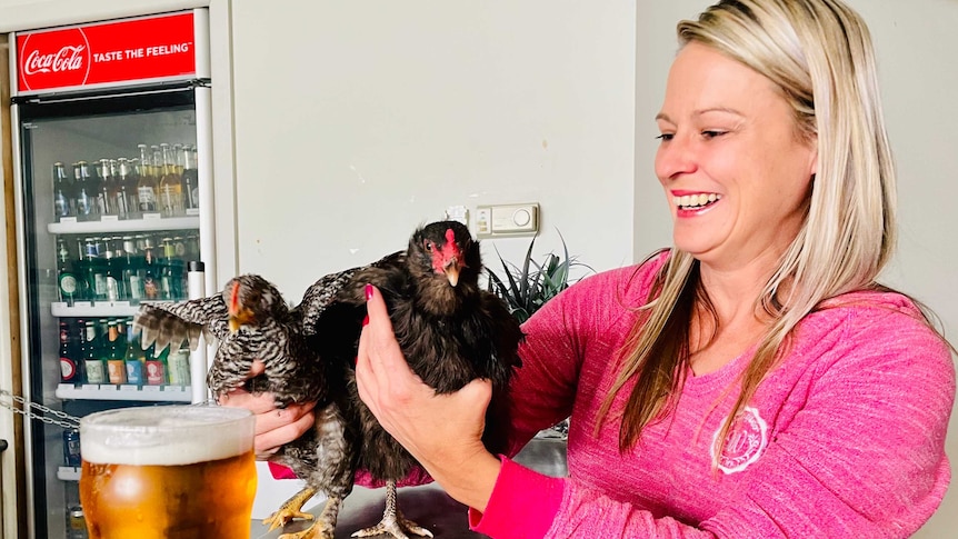 Two chooks on the bar at the Paynesville pub, with owner Jaclyn Robinson.