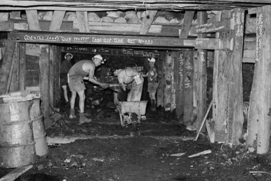Black and white image of men in mine site