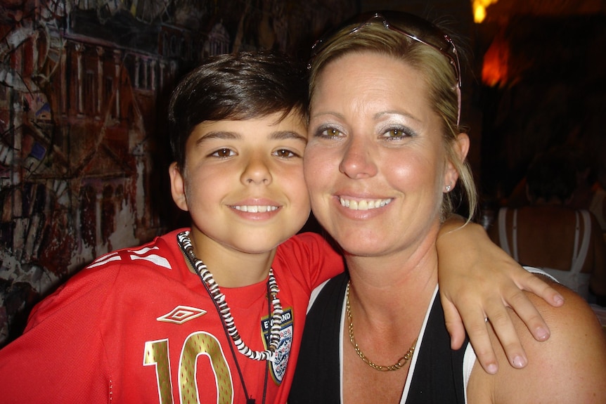 A picture of a smiling young boy and his mother 