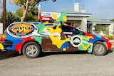 A brightly coloured Ford wagon that is set to be used in the Shitbox Rally.