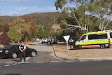 Police cordon off an area in Chisholm, ACT, where two men were found shot dead.