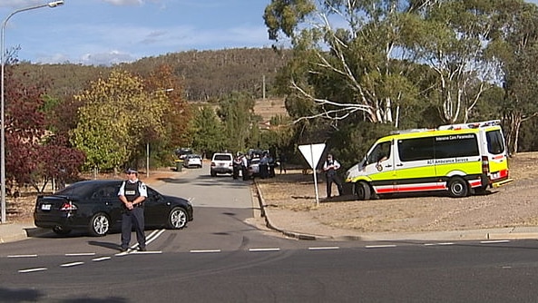 Police cordon off an area in Chisholm, ACT, where two men were found shot dead.