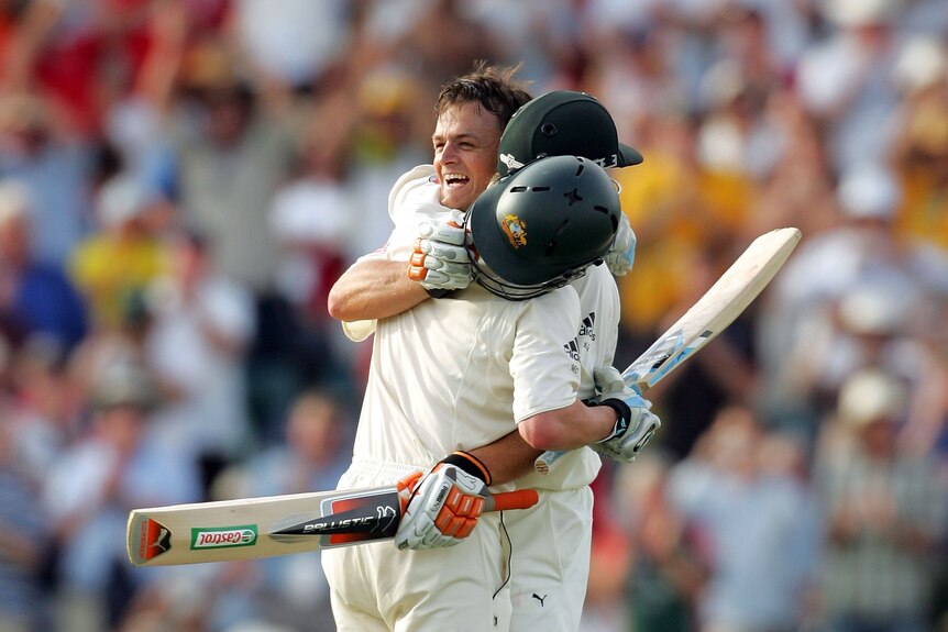 Adam Gilchrist is congratulated by teammate Michael Clarke after reaching his century during the third Ashes series in 2006