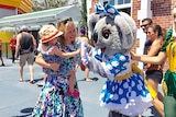 Tourism Minister Kate Jones and her daughter greet Dreamworld's koala mascot