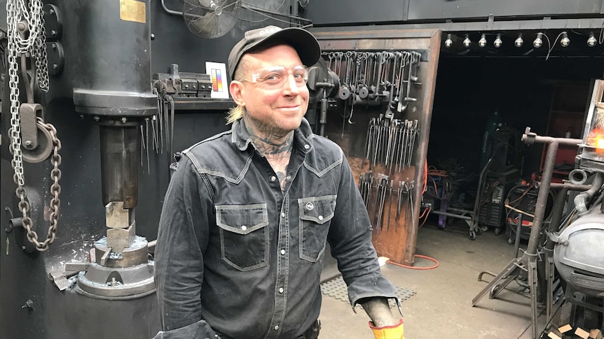 Pete Mattila the Blacksmith surrounded by tools in his workshop