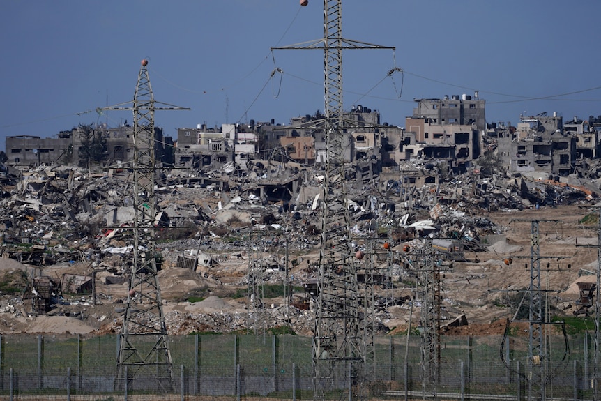 Rubble from destroyed buildings can be seen in the Gaza Strip near the border fence with Israel