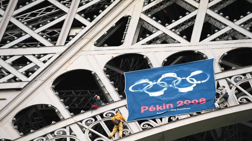 Reporters Without Borders activists set up a flag with the five Olympic rings turned into handcuffs on the Eiffel Tower while the torch was in Paris.